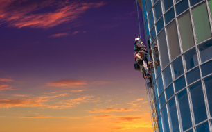 Facility management, man looking up at the buildings, dressed in business casual with his hands on his hips ready to take on a challenge